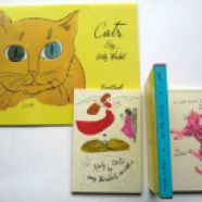 A bind of two books about cats, one "by Andy Warhol's mother"